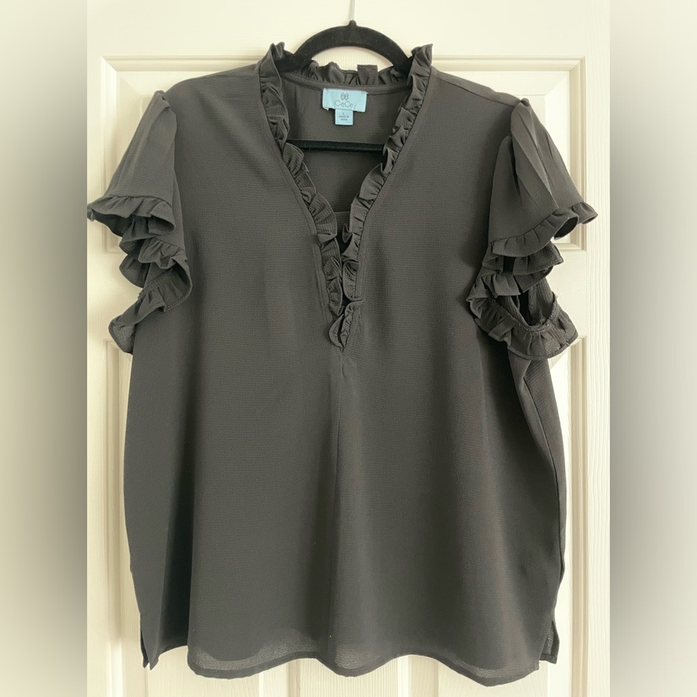 Women’s short sleeve blouse.CeCe brand. Ruffle detail. Excellent condition.